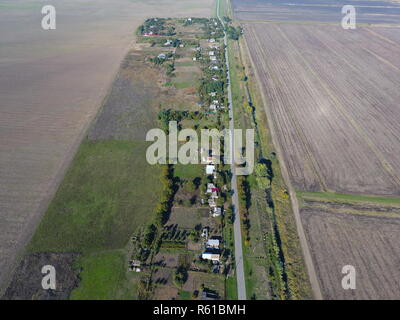 Top view of the village. One can see the roofs of the houses and gardens. Road in the village. Village bird's-eye view Stock Photo