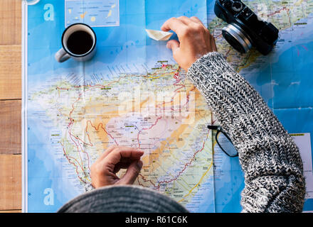 top view people planning the next destination travel top above view with map and coffee and photo camera on the table - wanderlust and vacation advent Stock Photo