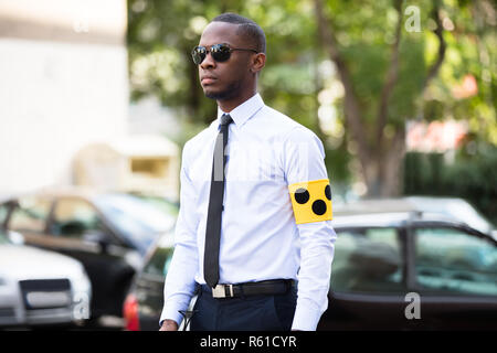 Blind Man Wearing Yellow Arm Band And Sunglasses Stock Photo