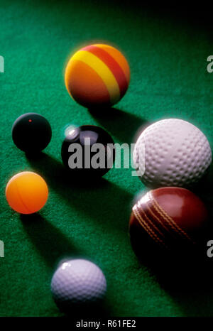 golf cricket billiard snooker squash balls on green table Stock Photo