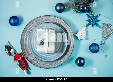 Christmas table place setting on blue background. Holidays background. Stock Photo