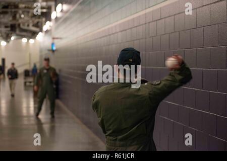 SEATTLE (May 5, 2017) Capt. Greg Huffman, USS John C. Stennis' (CVN 74) commanding officer, warms up to throw the ceremonial first pitch at a Seattle Mariners baseball game with Capt. Scott Miller, John C. Stennis' executive officer. Huffman threw out the first pitch at Safeco Field as part of “John C. Stennis Family Night” hosted by the Mariners and John C. Stennis’ Morale, Welfare, and Recreation department. John C. Stennis is conducting a planned incremental availability (PIA) at Puget Sound Naval Shipyard and Intermediate Maintenance Facility, during which the ship is undergoing scheduled  Stock Photo