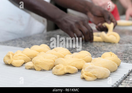 baker prepares bread dough in his bakehouse Stock Photo