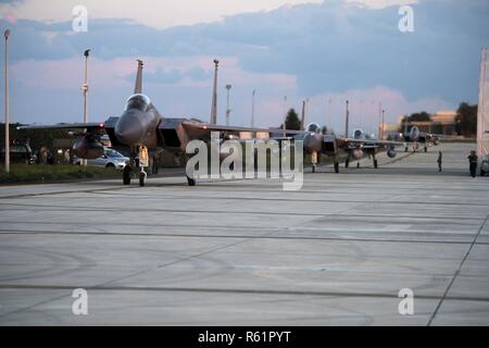 Four F-15C Eagles assigned to the 493rd Fighter Squadron taxi at Amendola Air Base, Italy, Nov. 16, 2018. F-15C Eagles and an F-15D Eagle will be participating in the NATO Tactical Leadership Programme 18-4. TLP has prepared hundreds of NATO and allied forces’ flight leaders to be mission commanders. Stock Photo