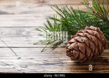 Pine cones and spruce branches on wooden background. Selective focus.Copy space. Stock Photo