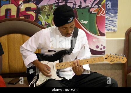 Spc. Nicholas Nelson, assigned to the 8th MP Brigade plays guitar at the Sustainment Bistro during the a Thanksgiving lunch for Soldiers, Family and Civilians Nov. 21 at Schofield Barracks, Hawaii. Stock Photo