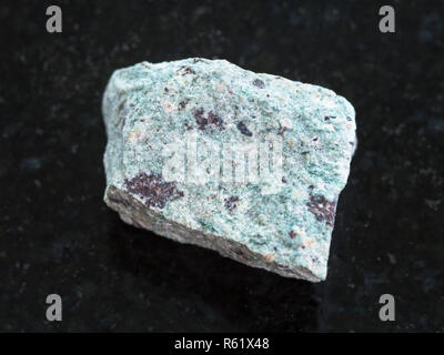 raw Trachyte stone on dark background Stock Photo
