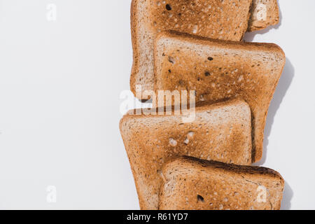 top view of stack of crunchy toasts on white surface Stock Photo