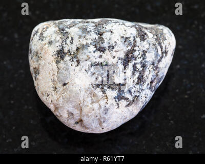 piece of Diorite stone on dark background Stock Photo