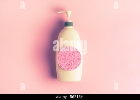Large package shampoo, shower gel, body cream, Spa, sponge. Top view copy space pink background Stock Photo