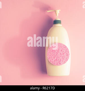 Large package shampoo, shower gel, body cream, Spa, sponge. Top view copy space pink background Stock Photo