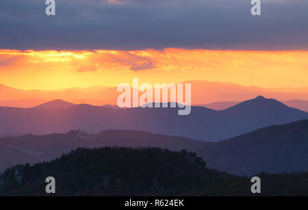 Sunset over color mountain silhouette. Stock Photo