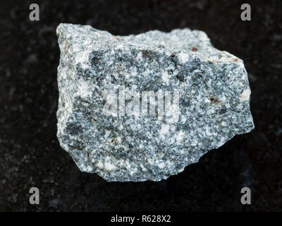 raw Diorite stone on dark background Stock Photo