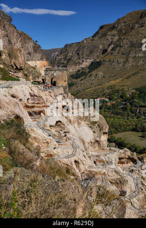 VARDZIA, GEORGIA - SEPTEMBER 25, 2018: Ancient cave monastery Vardzia, tourists near the ruins of the bell tower Stock Photo