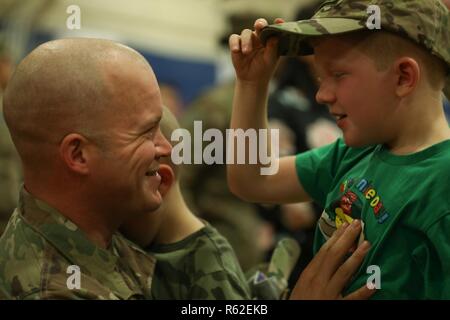 Staff Sgt. Nikolaus Sweger, assigned to 704th Brigade Support Battalion, 2nd Infantry Brigade Combat Team, 4th Infantry Division, is reunited with his family following a homecoming ceremony at the William Bill Reed Special Event Center, Fort Carson, Colo., Nov. 17, 2018. The 2IBCT, 4th Inf. Div. deployed in February to Afghanistan to support the Resolute Support mission of conducting train, advise and assist operations that enable Afghan National Defense and Security Forces to increase security and stability in order to prevent terrorist safe havens.  Additionally one battalion deployed to Kos Stock Photo