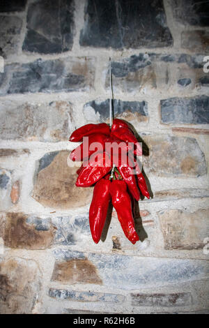 typical dried peppers of Basilicata region, so called peperoni cruschi, hanging to dry at sun Stock Photo