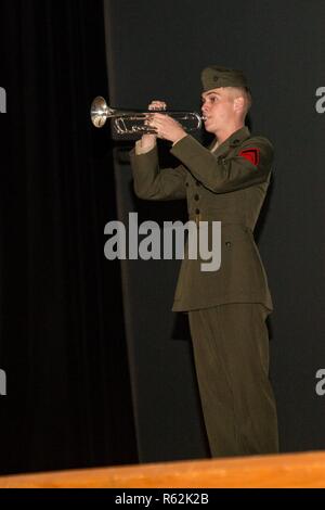 A U.S. Marine with the 2nd Marine Division (2d MARDIV) band, plays taps during the end of the Battle of Tarawa 75th Anniversary ceremony on Camp Lejeune, N.C., Nov. 20, 2018. The Marines and Sailors of 2d MARDIV honored those who served in the battle by conducting a historical overview followed by a ceremony. Stock Photo