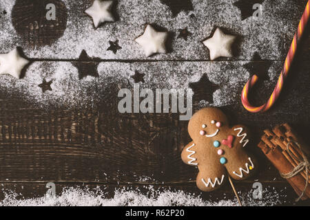 Christmas composition with gingerbread man on the wooden table top view Stock Photo