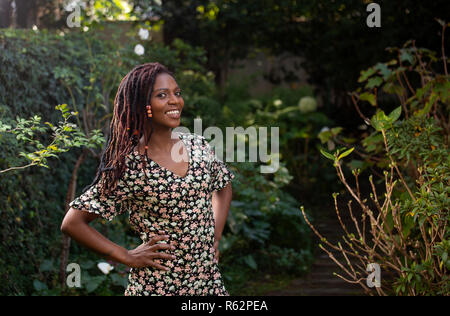 An African woman standing in a garden Stock Photo