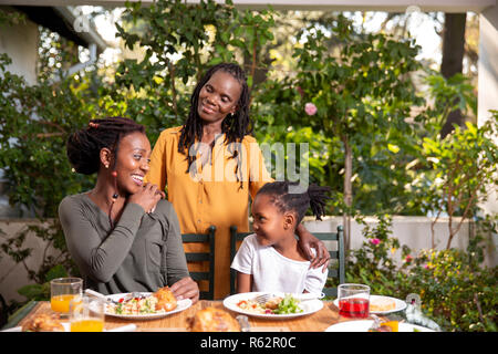 Three generations of women sitting at a lunch table Stock Photo