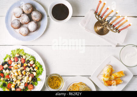 Traditional Hanukkah dishes on the white wooden table top view Stock Photo