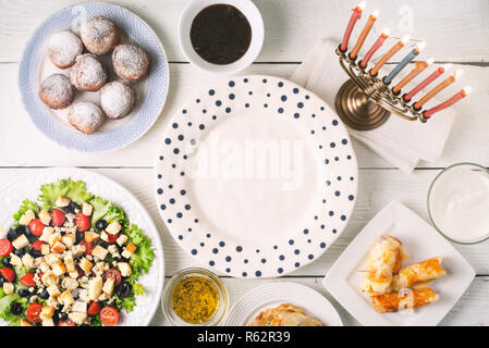 Traditional Hanukkah dishes on the white wooden table top view Stock Photo