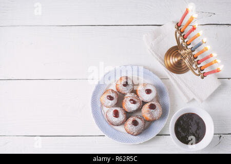 Traditional Hanukkah dishes on the white wooden table top view Stock Photo