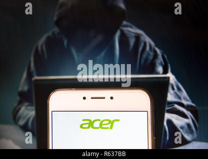 Hong Kong, China. 23rd Nov, 2018. Taiwanese multinational hardware and electronics corporation Acer logo is seen on an Android mobile device with a figure of hacker in the background. Credit: Miguel Candela/SOPA Images/ZUMA Wire/Alamy Live News Stock Photo