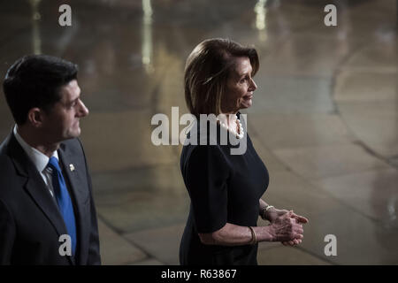 Washington, District of Columbia, USA. 3rd Dec, 2018. WASHINGTON, DC - DECEMBER 3 : Outgoing Speaker Paul D. Ryan and Nancy Pelosi walk away after paying their respects to former president George H.W. Bush as he lies in State at the U.S. Capitol Rotunda on Capitol Hill on Monday, Dec. 03, 2018 in Washington, DC. (Photo by Jabin Botsford/Pool) Credit: Jabin Botsford/CNP/ZUMA Wire/Alamy Live News Stock Photo