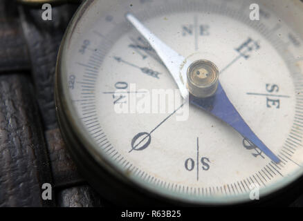 close up view of grunge compass points to true north  on wooden background Stock Photo