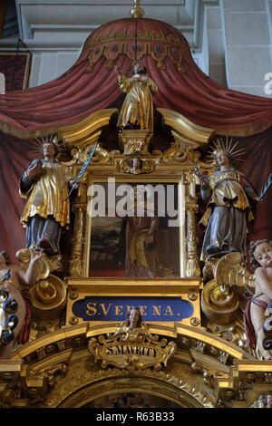 Saint Verena surrounded by the statues of Saints, altar of Saint Maurice in the church of St. Leodegar in Lucerne, Switzerland Stock Photo