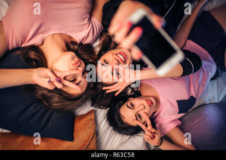 Cheery young three multiethnic girls friends posing isolated over pink wall  background. Stock Photo | Adobe Stock