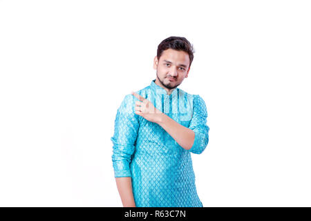 Indian man in ethnic wear , showing gesture with hand , isolated over white background Stock Photo