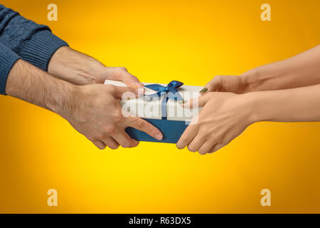The closeup picture of man and woman's hands with gift box Stock Photo