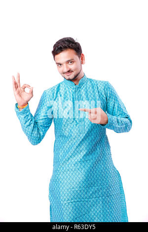 Indian man in ethnic wear , showing gesture with hand , isolated over white background Stock Photo