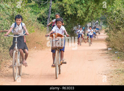 PHNOM PENH, CAMBODIA - JANUARY 05 2015: Cambodian children are students going to classes at the school on bicycles Stock Photo