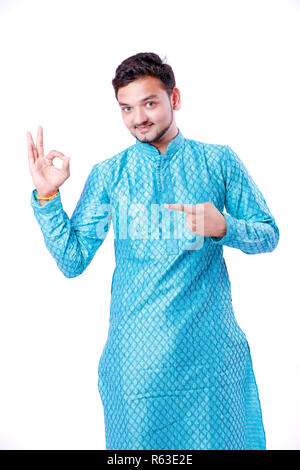 Indian man in ethnic wear , showing gesture with hand , isolated over white background Stock Photo