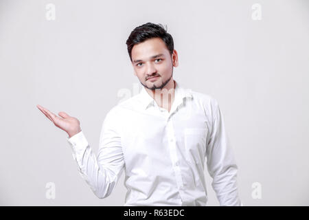 Young Indian man showing on white background Stock Photo