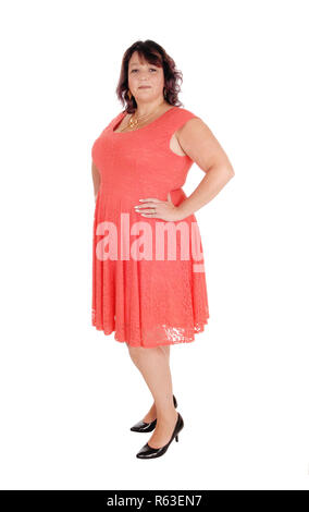 A plus size woman standing in a dress Stock Photo