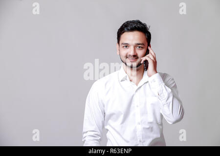 Young indian man using mobile Stock Photo