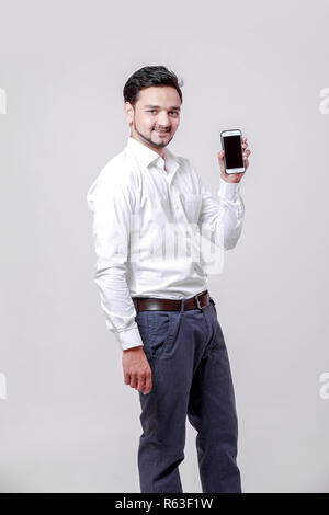 Young indian man using mobile Stock Photo