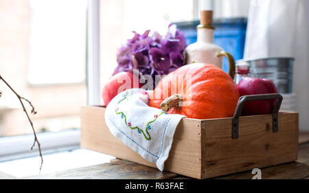 Flowers and pumpkin for autumn home decor. Beautiful composition on the window. Coziness and comfort. Free space for text Stock Photo
