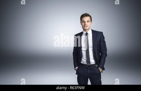 confident businessman with hands in pocket studio shot Stock Photo