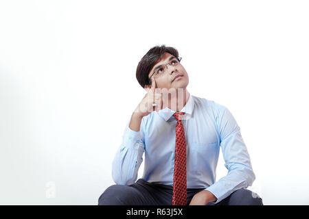Young Indian business man thinking Stock Photo
