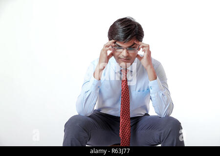 Young indian businessman with headache over white background Stock Photo