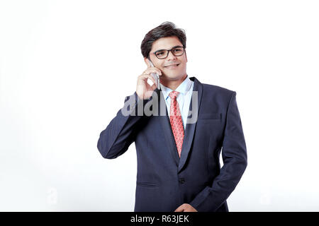 Young Indian businessmen talking on mobile over isolated background Stock Photo