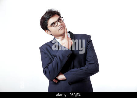 Young Indian business man thinking Stock Photo