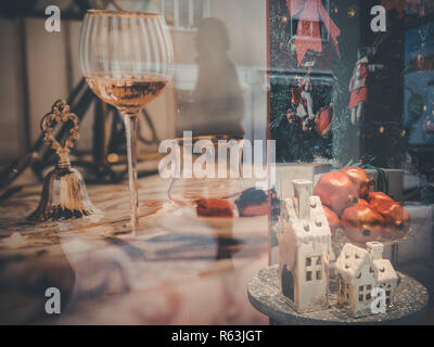 Rimini, italy, December 2018  People walks for the street and are reflected from forniture showcase. Christmas atmosfere, Christmas showcase mounting. Stock Photo