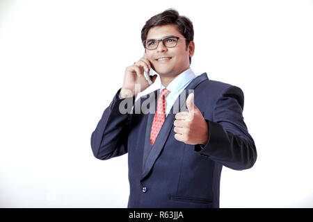 Young Indian businessmen talking on mobile over isolated background Stock Photo