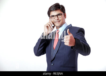 Young Indian businessmen talking on mobile over isolated background Stock Photo